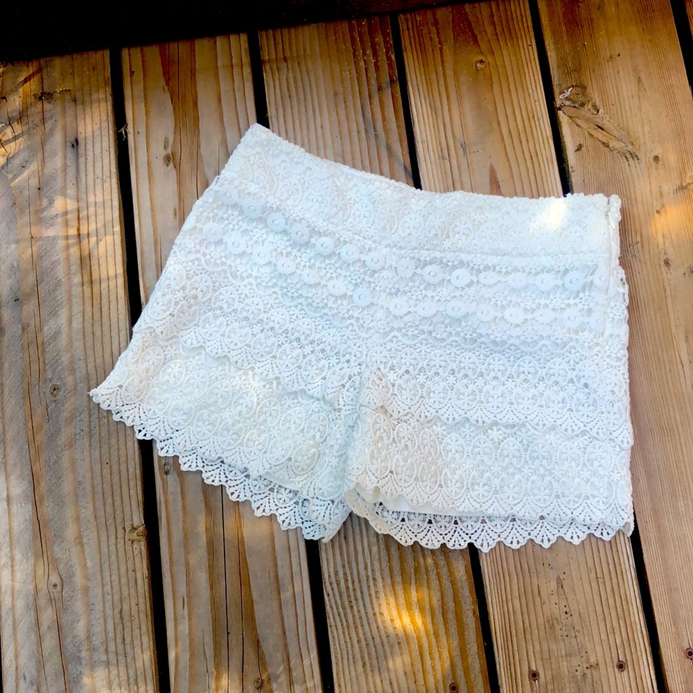 Lace lined off white shorts .